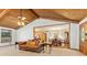 Inviting living room features wood paneled ceiling, ample lighting and open flow to dining room at 1981 Luke Edwards Rd, Dacula, GA 30019