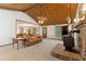 Bright living room with a brick fireplace, wood ceiling, and adjacent dining area at 1981 Luke Edwards Rd, Dacula, GA 30019