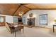 Open living room with a brick fireplace, wood ceiling, and view of the front door at 1981 Luke Edwards Rd, Dacula, GA 30019