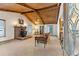 Cozy living room with wood-beamed ceiling, brick fireplace, and inviting decor at 1981 Luke Edwards Rd, Dacula, GA 30019