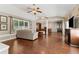 Open-concept living room featuring hardwood floors, comfortable seating, and an entertainment center at 1981 Luke Edwards Rd, Dacula, GA 30019