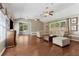 Open living room with vaulted ceiling, hardwood floors, and comfortable seating arrangement at 1981 Luke Edwards Rd, Dacula, GA 30019