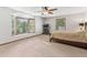 Spacious main bedroom featuring a ceiling fan, a bay window, and neutral carpeting at 1981 Luke Edwards Rd, Dacula, GA 30019