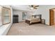 Bright main bedroom with a ceiling fan, a large window, and neutral carpeting at 1981 Luke Edwards Rd, Dacula, GA 30019