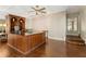 Bright office area with dark wooden floors, large wooden desk, and bookcase at 1981 Luke Edwards Rd, Dacula, GA 30019