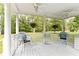 Inviting porch with white wicker chairs, ceiling fans, and decorative flowers for relaxing and enjoying the outdoors at 1981 Luke Edwards Rd, Dacula, GA 30019
