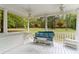 Cozy porch featuring cushioned seating, ceiling fans, and serene views of greenery, creating a relaxing outdoor space at 1981 Luke Edwards Rd, Dacula, GA 30019
