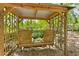 Outdoor sitting area featuring a wooden swing with views of the surrounding trees and landscape at 1981 Luke Edwards Rd, Dacula, GA 30019