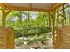 Outdoor swing set offering scenic views of the serene creek and lush green landscape at 1981 Luke Edwards Rd, Dacula, GA 30019