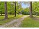 Scenic yard with trees and a gazebo in the background, surrounded by natural beauty at 1981 Luke Edwards Rd, Dacula, GA 30019