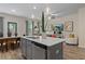 Open concept kitchen features quartz countertop island and stainless steel appliances at 352 Navigator Ln, Mcdonough, GA 30253