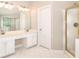 Bathroom featuring a double vanity, a large mirror, and a glass-enclosed shower with a gold frame at 931 Bonaventure Way, Lawrenceville, GA 30044