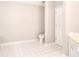 Bright bathroom with tile flooring, white fixtures, including a toilet, sink, and vanity at 931 Bonaventure Way, Lawrenceville, GA 30044