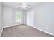 Spacious bedroom featuring carpet, white ceiling fan, closet and natural light from the window at 931 Bonaventure Way, Lawrenceville, GA 30044