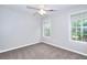 Light-filled bedroom with neutral paint, ceiling fan, two windows, and comfortable carpeting at 931 Bonaventure Way, Lawrenceville, GA 30044