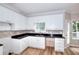 Well-lit kitchen showcasing white cabinets, dark countertops, and modern fixtures at 931 Bonaventure Way, Lawrenceville, GA 30044