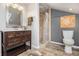 Bathroom featuring a modern vanity, tiled shower, and stylish wood-look flooring at 136 Peachtree Memorial Nw Dr # Va2, Atlanta, GA 30309