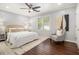 Comfortable bedroom with hardwood floors, natural light, and neutral decor at 136 Peachtree Memorial Nw Dr # Va2, Atlanta, GA 30309