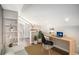 Bright office featuring a modern desk, shelving, and view to an adjacent bathroom providing functional workspace at 136 Peachtree Memorial Nw Dr # Va2, Atlanta, GA 30309
