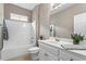 Bright bathroom featuring a shower-tub combo with white tiling, and a white vanity with a large mirror at 226 Hames Rd # 335, Woodstock, GA 30188