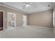 Large bedroom with neutral carpet and paint, plus a view into an ensuite bathroom with white vanity at 226 Hames Rd # 335, Woodstock, GA 30188