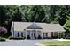 Community clubhouse featuring a covered entrance, well-manicured landscaping, and ample parking at 226 Hames Rd # 335, Woodstock, GA 30188