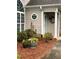 Charming front entrance with decorative wreath, octagon window, flower pots, and well-maintained landscaping at 226 Hames Rd # 335, Woodstock, GA 30188
