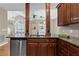 A kitchen area is shown with brown cabinets, granite counters, stainless dishwasher, and decoratively displayed items at 226 Hames Rd # 335, Woodstock, GA 30188