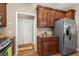 The kitchen showcases wood cabinets, granite countertops, stainless steel refrigerator, and an adjacent pantry at 226 Hames Rd # 335, Woodstock, GA 30188