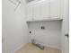 Functional laundry room featuring white cabinets, a washing machine hookup, and tiled flooring at 226 Hames Rd # 335, Woodstock, GA 30188