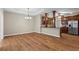 Open floor plan with hardwood floors, dining area, and partial view into the kitchen with stainless appliances at 226 Hames Rd # 335, Woodstock, GA 30188