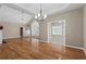 Bright living room with hardwood floors and open floor plan to a sunroom with lots of natural light at 226 Hames Rd # 335, Woodstock, GA 30188