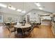 Community meeting room with tables, chairs, hardwood floors and high ceilings at 226 Hames Rd # 335, Woodstock, GA 30188