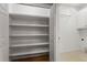 Spacious pantry with white shelving, providing ample storage space, and a door to laundry room at 226 Hames Rd # 335, Woodstock, GA 30188