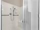 Walk-in shower featuring grab bars, a handheld shower head, and a built-in seat at 226 Hames Rd # 335, Woodstock, GA 30188