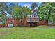 Backyard of a brick home with a garage and deck at 2417 Jade Dr, Lawrenceville, GA 30044