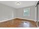 Bedroom featuring hardwood floors and a large window at 2417 Jade Dr, Lawrenceville, GA 30044