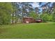 Beautiful brick home surrounded by mature trees and lush green lawn at 2417 Jade Dr, Lawrenceville, GA 30044