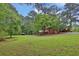 A house surrounded by mature trees and lush green lawn at 2417 Jade Dr, Lawrenceville, GA 30044