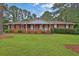 Charming brick home with a well-manicured lawn and a cozy front porch at 2417 Jade Dr, Lawrenceville, GA 30044