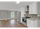 Modern kitchen with stainless steel appliances, white cabinets, mosaic backsplash, and an open layout at 2417 Jade Dr, Lawrenceville, GA 30044