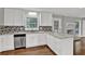 Modern kitchen with white cabinetry, granite counters, stainless steel appliances, and an island at 2417 Jade Dr, Lawrenceville, GA 30044