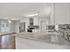 Bright kitchen featuring marble counters, stainless steel appliances, and modern tile backsplash at 2417 Jade Dr, Lawrenceville, GA 30044