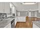 Bright kitchen featuring white cabinets, stainless steel appliances, and an open layout at 2417 Jade Dr, Lawrenceville, GA 30044