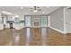 Open-concept living room featuring hardwood floors and a fireplace that flows into the kitchen at 2417 Jade Dr, Lawrenceville, GA 30044