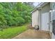 Backyard with lush greenery, a concrete patio and exterior storage access at 3733 Sidney Lanier Blvd, Duluth, GA 30096