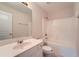 Bathroom with single sink vanity, mirror, and tub with tiled surround at 3733 Sidney Lanier Blvd, Duluth, GA 30096