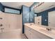 Primary bathroom with double sink vanity, soaking tub with shower, and framed mirror with modern lighting at 3733 Sidney Lanier Blvd, Duluth, GA 30096