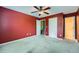 Bedroom with red walls, neutral carpet, and doorways leading to bathroom at 3733 Sidney Lanier Blvd, Duluth, GA 30096