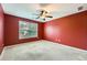 Bedroom showcasing neutral carpet, red walls, ceiling fan and bright window at 3733 Sidney Lanier Blvd, Duluth, GA 30096